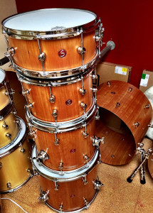 stacked cherry wood drum kit